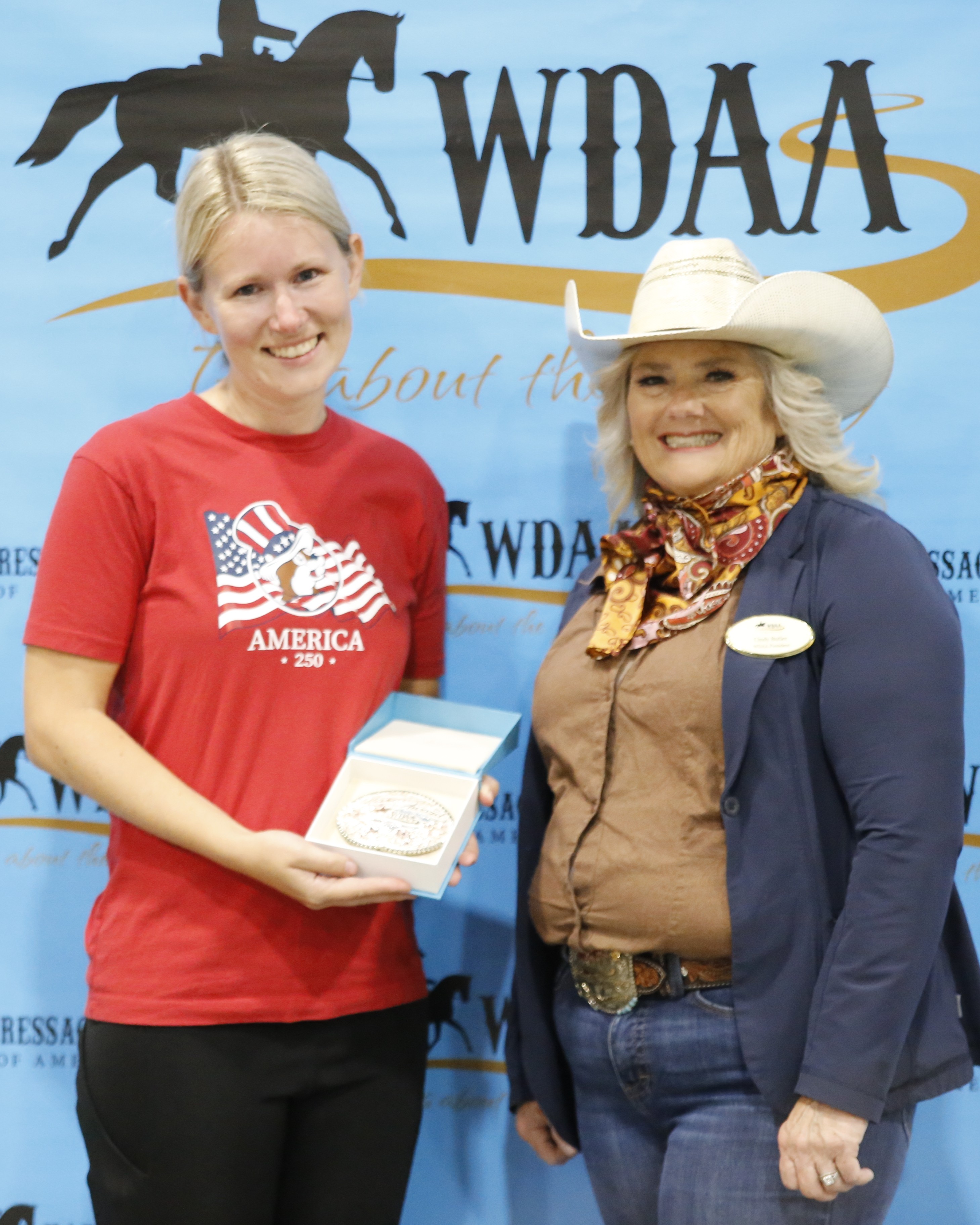 Karoline receives her Harmony Award buckle generously donated by Skyline Vaquero Silversmiths.